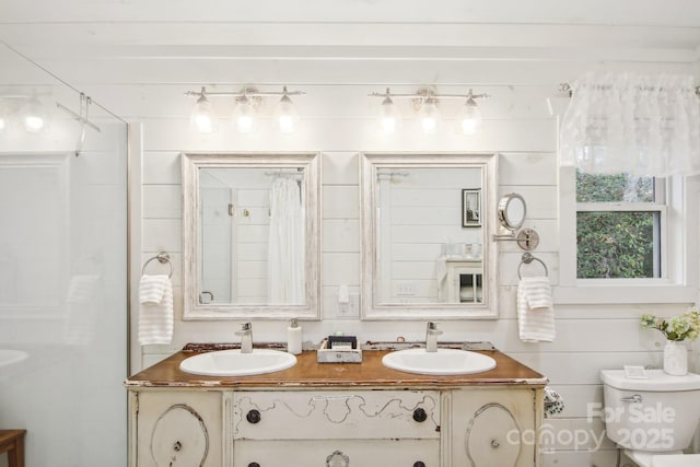 bathroom featuring walk in shower, vanity, and toilet