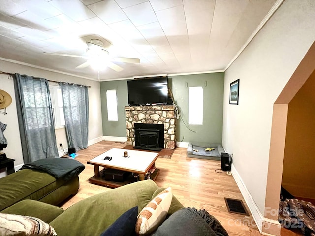 living room with hardwood / wood-style flooring, ceiling fan, and crown molding