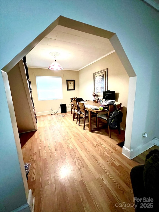 interior space featuring crown molding and light hardwood / wood-style flooring