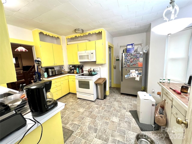 kitchen featuring pendant lighting and white appliances