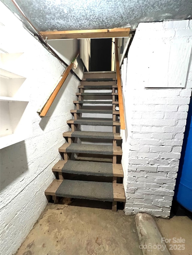 stairs featuring concrete floors