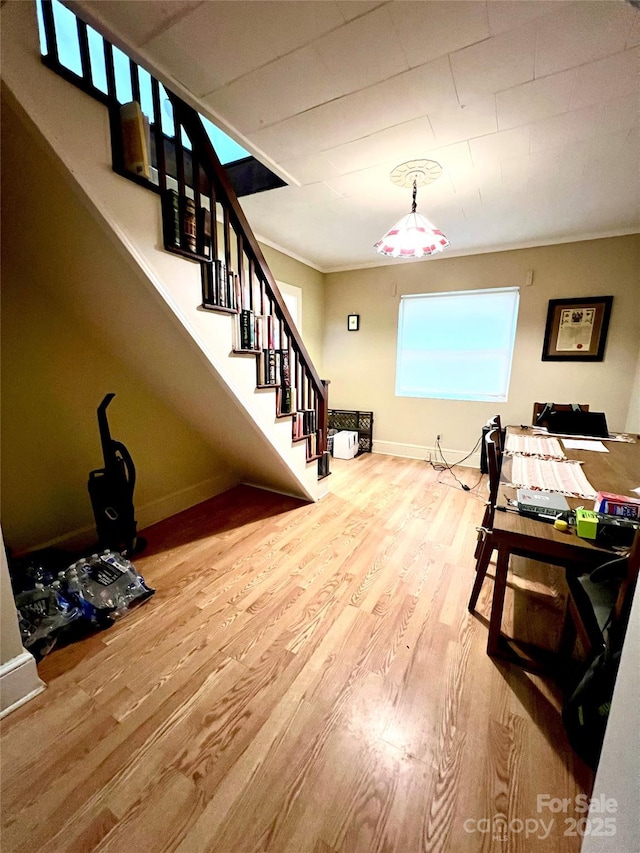 dining space featuring hardwood / wood-style floors and ornamental molding