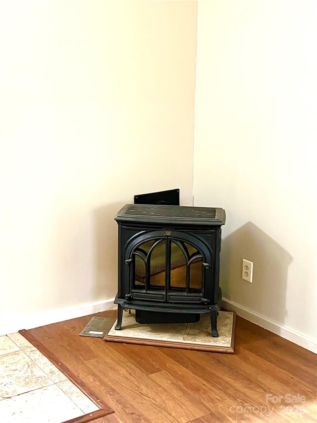 details featuring hardwood / wood-style flooring and a wood stove