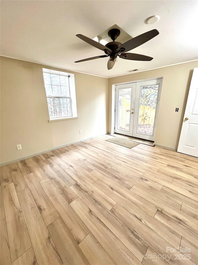 spare room featuring ceiling fan, french doors, and light hardwood / wood-style flooring