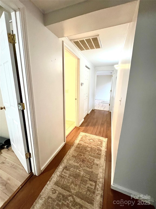 hallway with light hardwood / wood-style floors