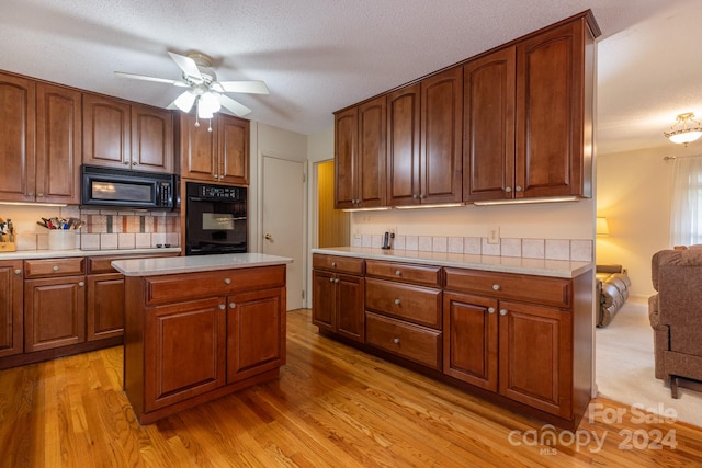 kitchen featuring ceiling fan, a textured ceiling, black appliances, and light hardwood / wood-style flooring