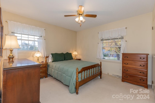 bedroom with light colored carpet and ceiling fan