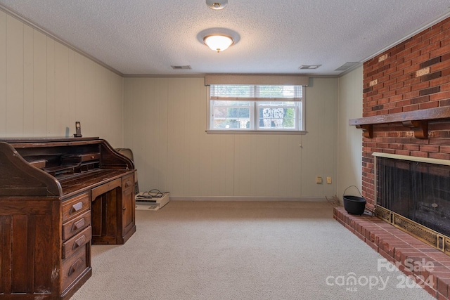 office area with a fireplace, light colored carpet, a textured ceiling, and crown molding