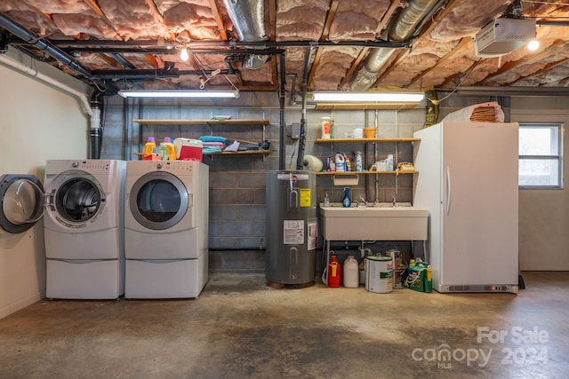 basement with electric water heater, separate washer and dryer, sink, and white refrigerator