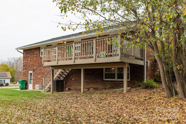 back of property with central AC unit and a wooden deck