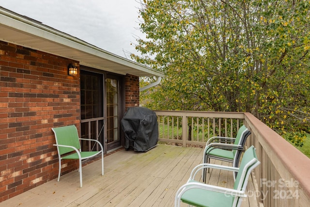 wooden deck with a grill