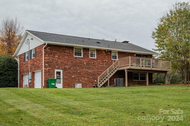 back of house with central AC, a garage, a lawn, and a deck