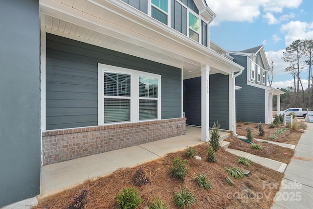 view of exterior entry with a porch