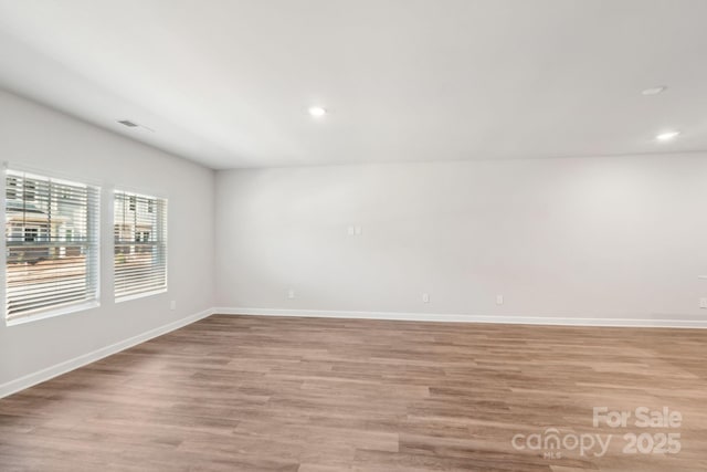 spare room featuring light hardwood / wood-style floors