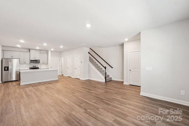 unfurnished living room featuring light wood-type flooring