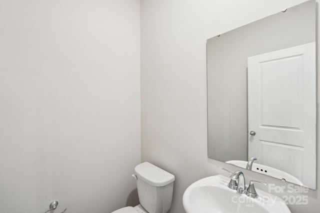 bathroom featuring sink and toilet