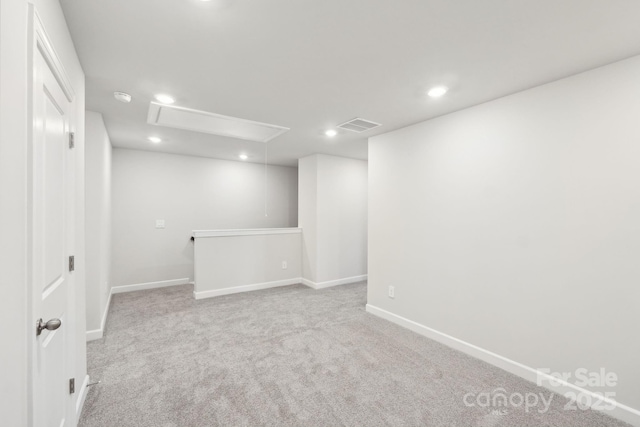 unfurnished room featuring light colored carpet