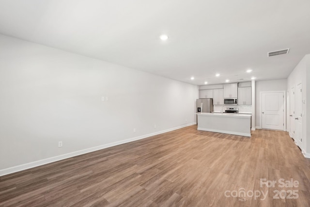 unfurnished living room with light hardwood / wood-style flooring