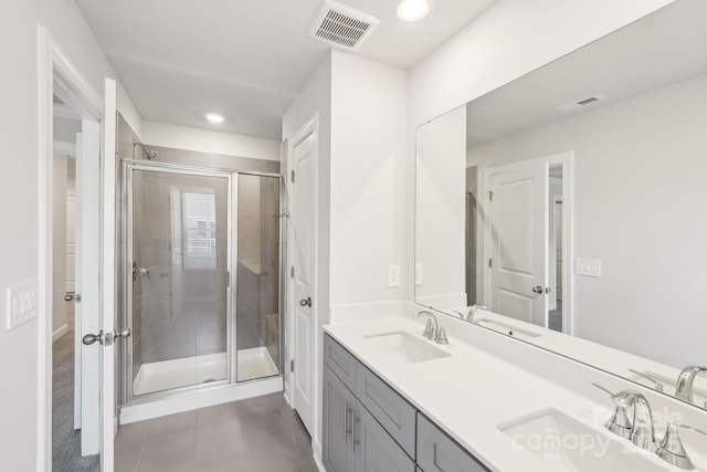 bathroom featuring an enclosed shower, vanity, and tile patterned flooring