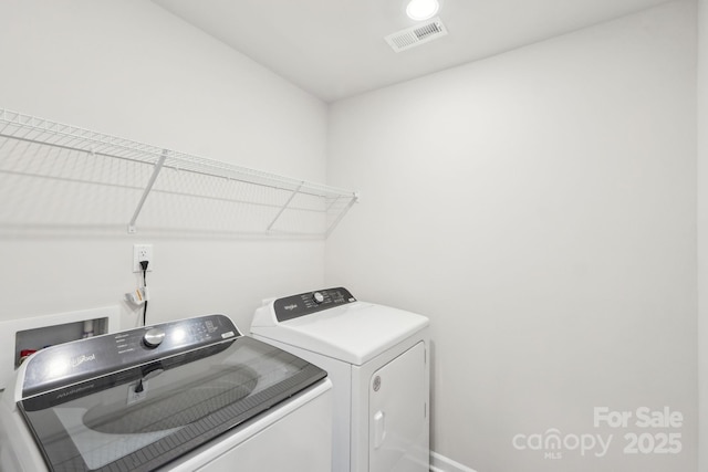 clothes washing area featuring washer and dryer