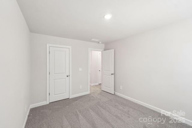 unfurnished bedroom featuring light colored carpet