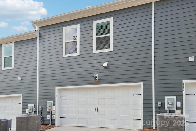 view of property exterior featuring cooling unit and a garage