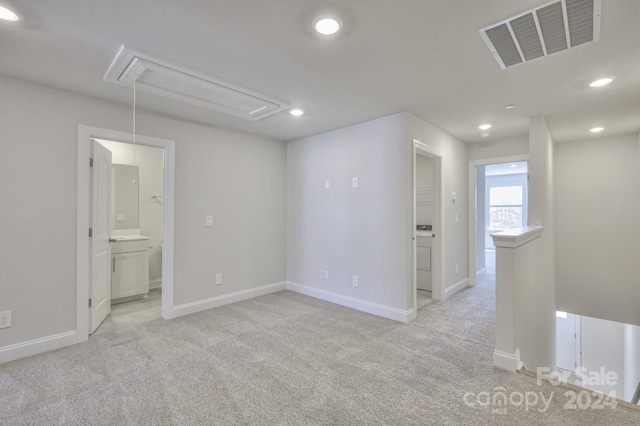 unfurnished room featuring light colored carpet