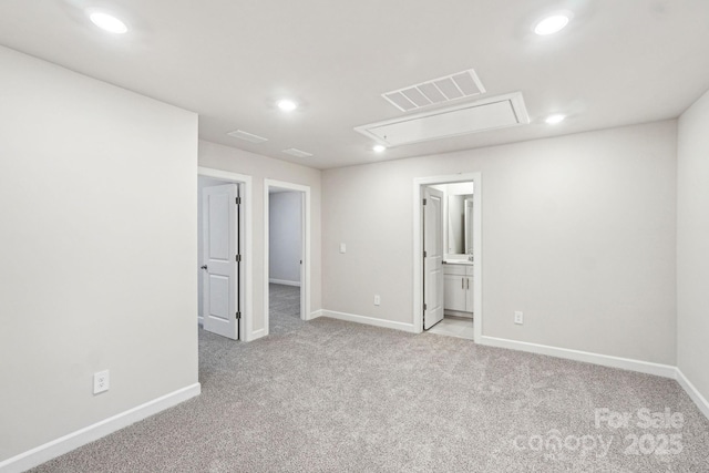 spare room featuring light colored carpet