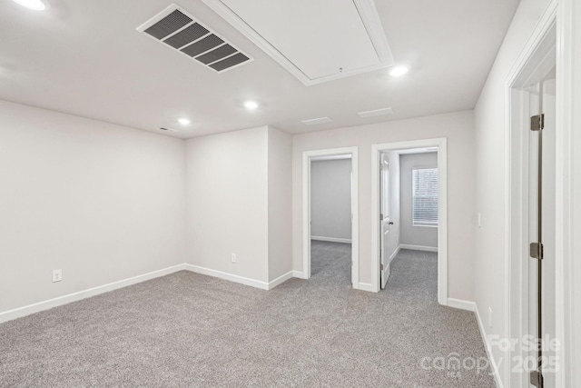 spare room featuring light colored carpet