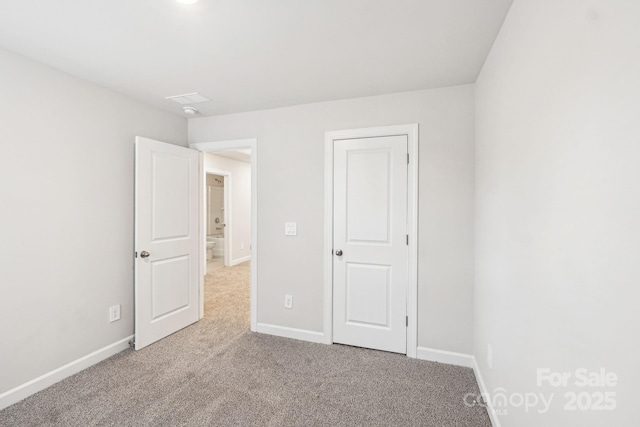 unfurnished bedroom with light colored carpet