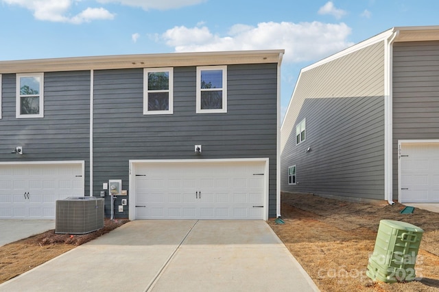 view of home's exterior with a garage and central AC unit