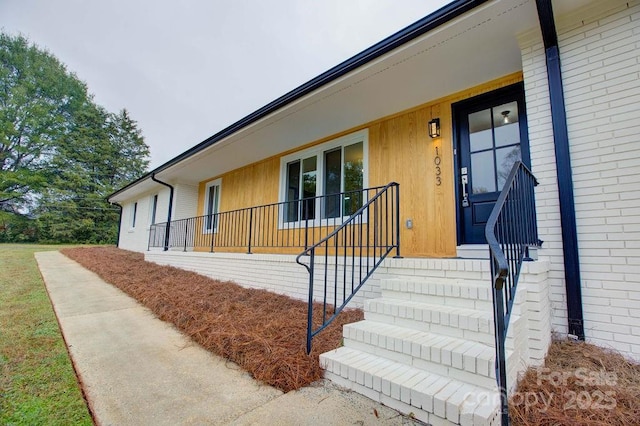 doorway to property featuring covered porch