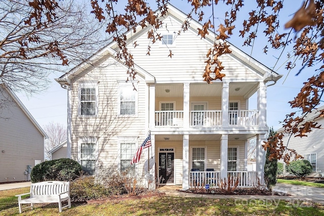 view of front facade featuring a balcony and covered porch