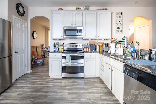 kitchen with sink, white cabinetry, and stainless steel appliances