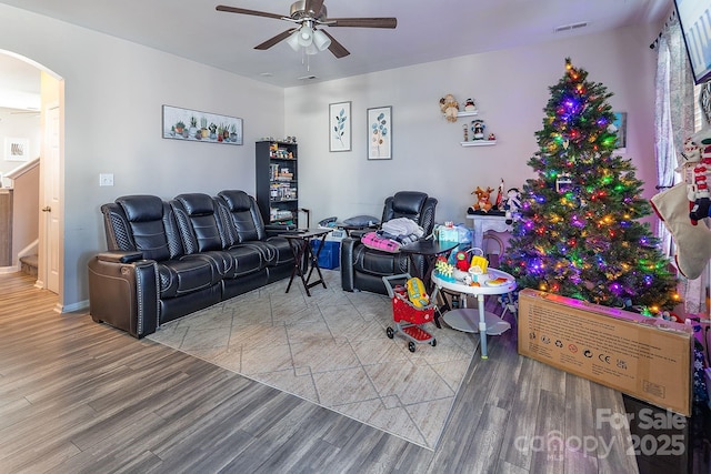 living room with hardwood / wood-style floors and ceiling fan