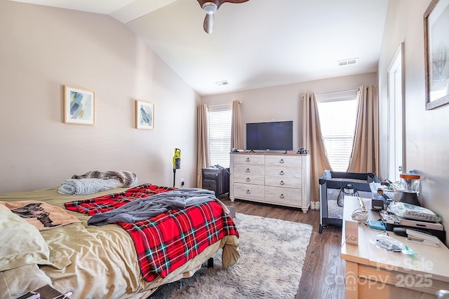 bedroom with dark hardwood / wood-style flooring, ceiling fan, and lofted ceiling