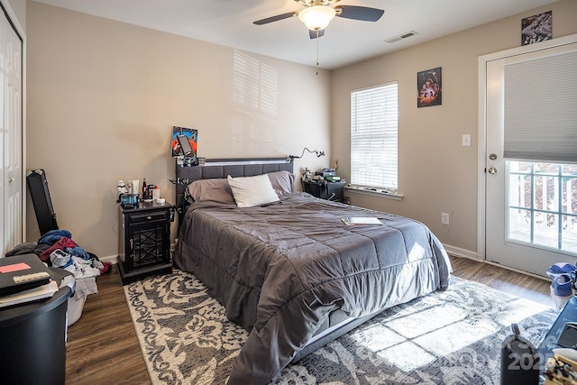 bedroom with dark hardwood / wood-style flooring and ceiling fan