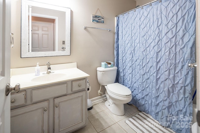 bathroom with tile patterned floors, a shower with curtain, vanity, and toilet