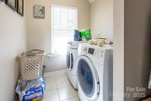 washroom with light tile patterned flooring and washing machine and dryer