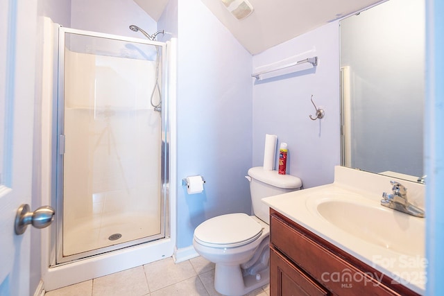 bathroom featuring tile patterned flooring, vanity, toilet, and a shower with door