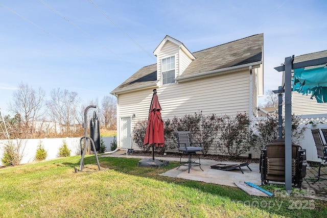 rear view of house with a patio area and a yard