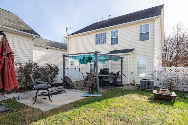 rear view of property featuring a pergola, a patio, a lawn, and central air condition unit