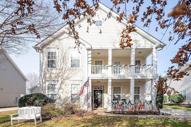 view of front of property with covered porch and a balcony