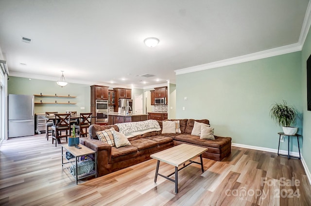 living room featuring light hardwood / wood-style flooring and crown molding