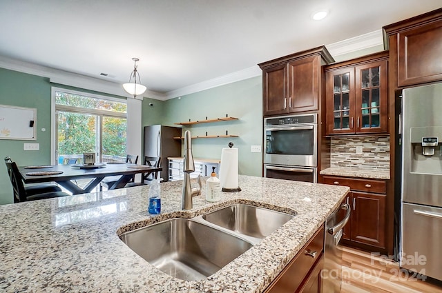 kitchen with crown molding, appliances with stainless steel finishes, decorative light fixtures, decorative backsplash, and sink