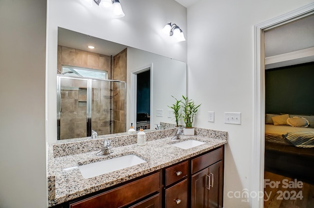 bathroom featuring vanity and an enclosed shower