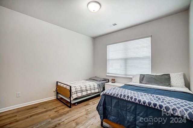 bedroom with hardwood / wood-style flooring