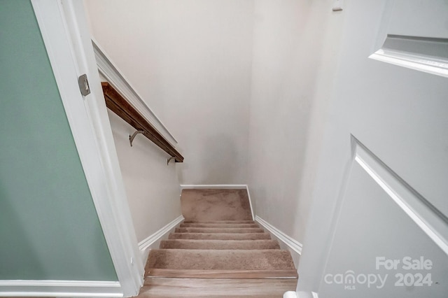 stairway featuring hardwood / wood-style floors