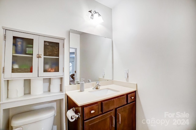 bathroom featuring toilet and vanity