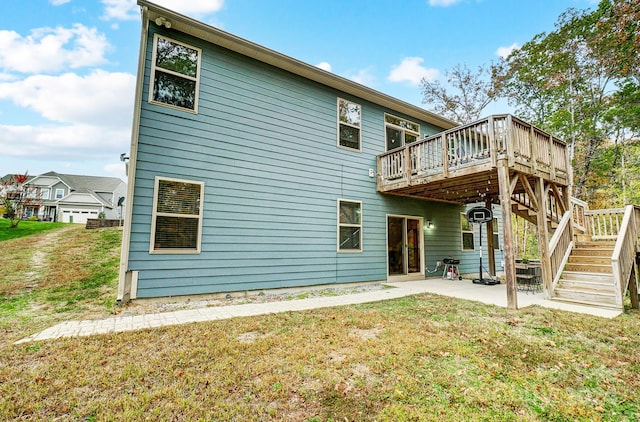 rear view of property featuring a deck, a lawn, and a patio